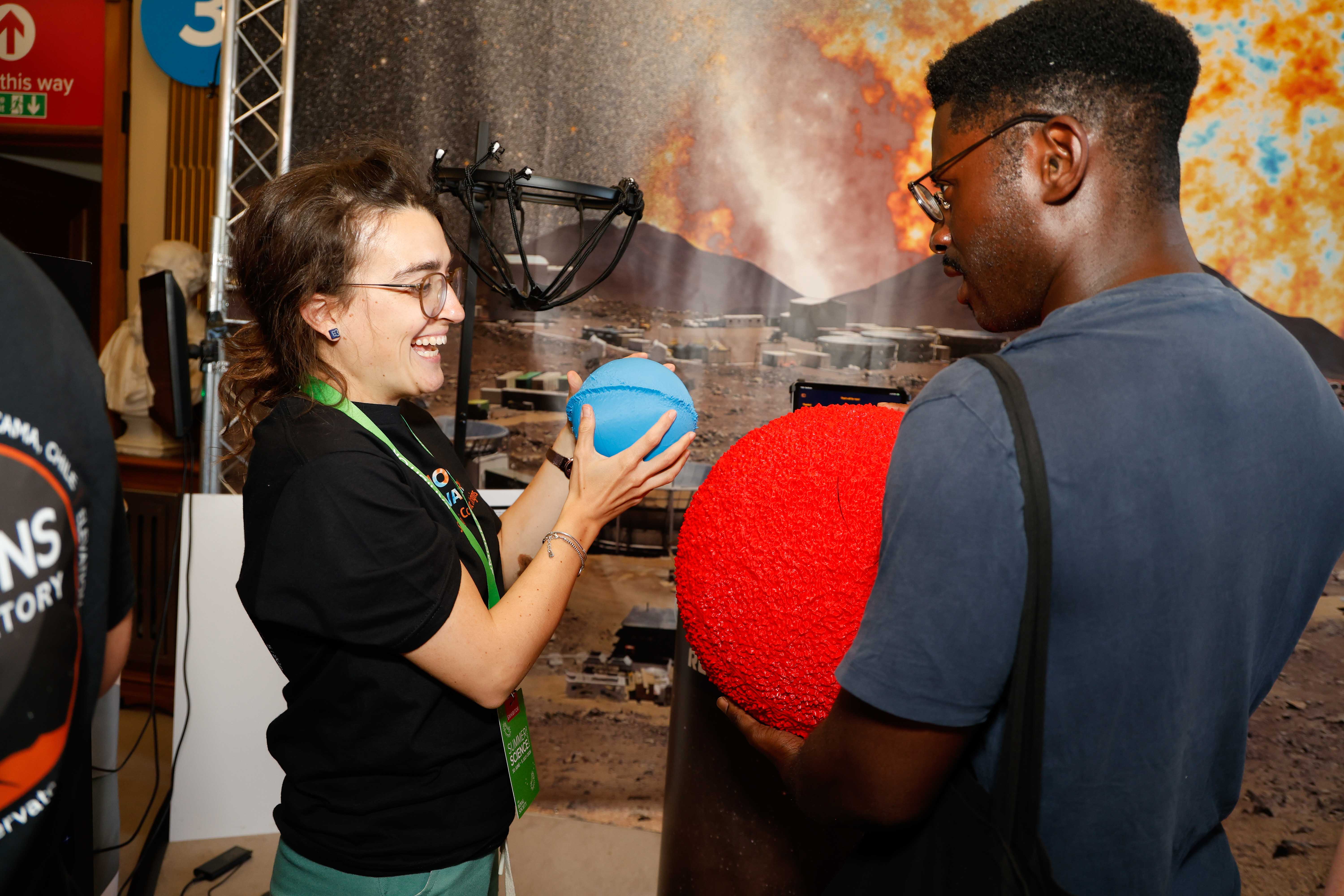 Talking to visitors at the Simons Observatory stand